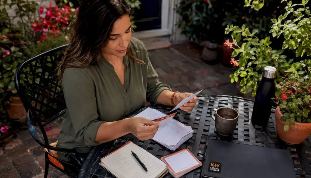 Woman organizing local loyalty program materials in coffee shop