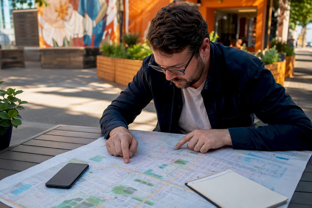 Business owner studying local neighborhood map