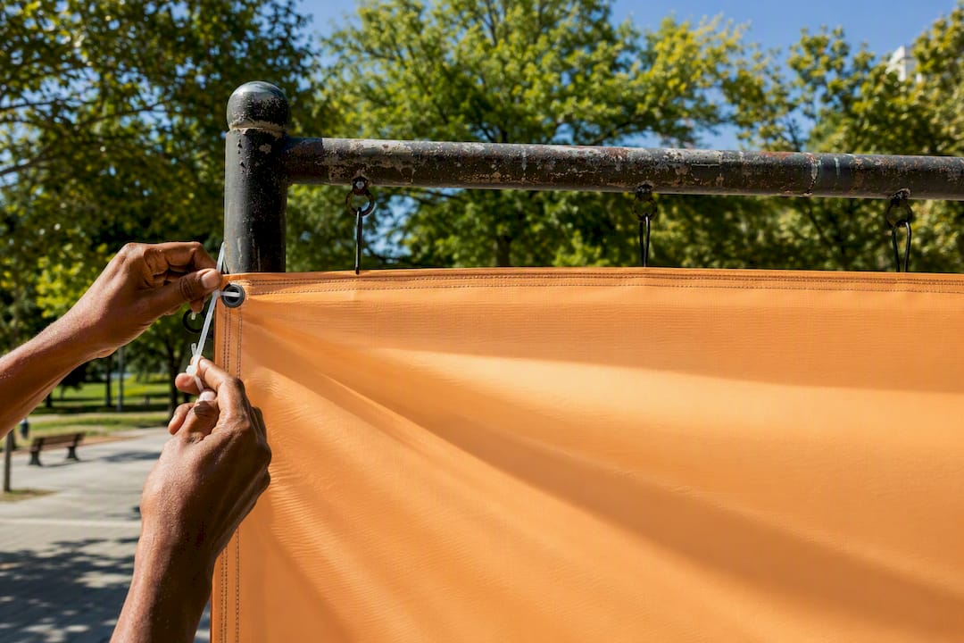 Hands installing local event banner outdoors