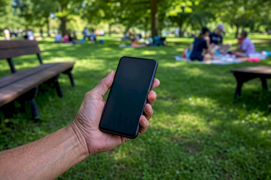 Hand holding GPS-enabled device outdoors